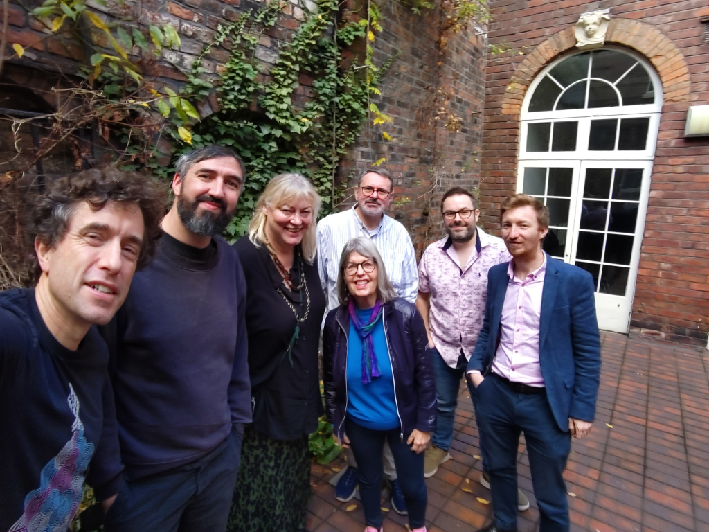 Selfie of a group of CSC Alumni and Liam Kelly